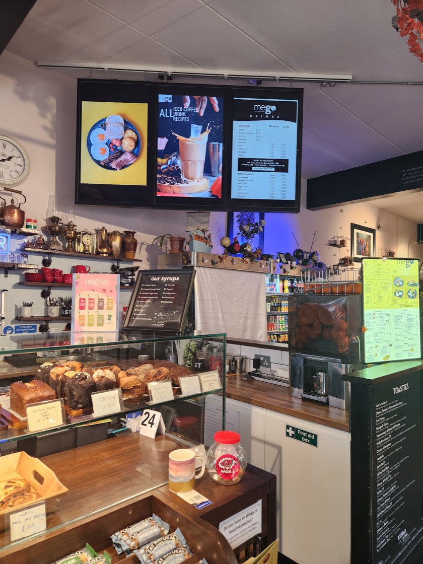 The Mego counter with the bakery display, brass antiques shelf and the drinks menu board above